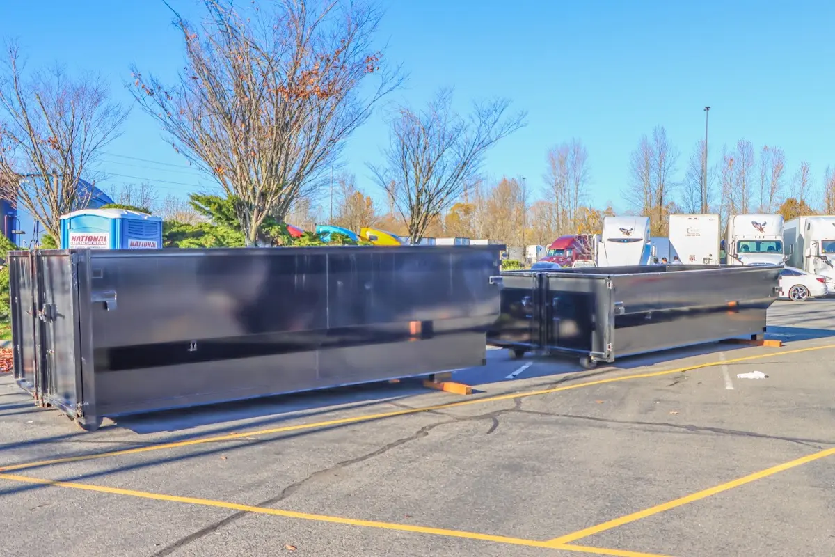 Professional dumpster rental service with roll-off container on residential driveway in Breaux Bridge